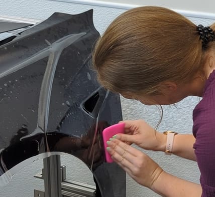 Annika Carter Applying Paint Protection Film At The Xpel Lab