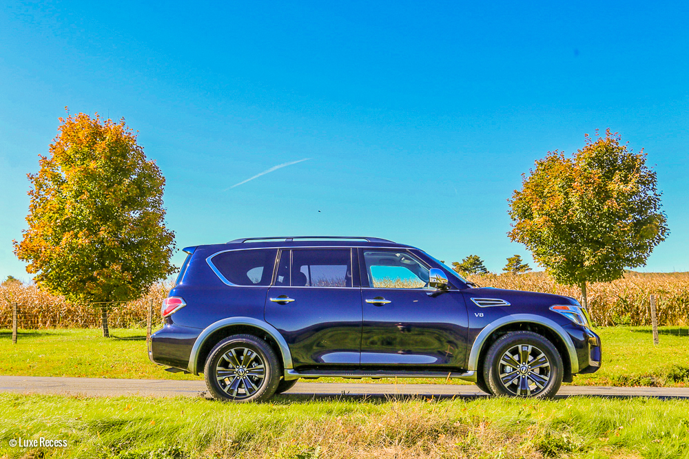 Blue Nissan Armada Among Fall Changing Trees 