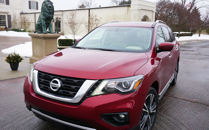 Red Nissan Pathfinder On Brick Driveway 