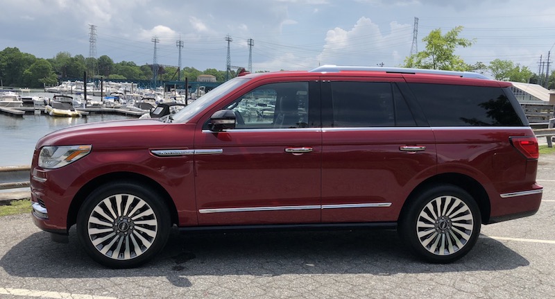 Red Lincoln Navigator Sitting Water Front 