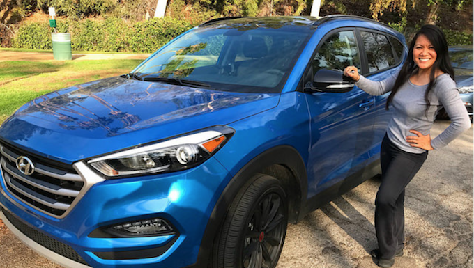 Woman Standing Next To A Blue 2017 Hyundai Tucson Compact Crossover 